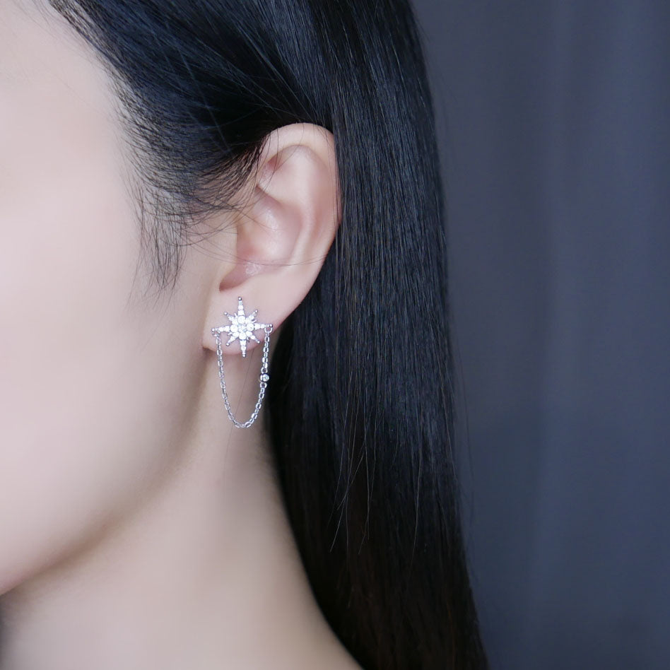 Model wearing silver Becca star drop earrings