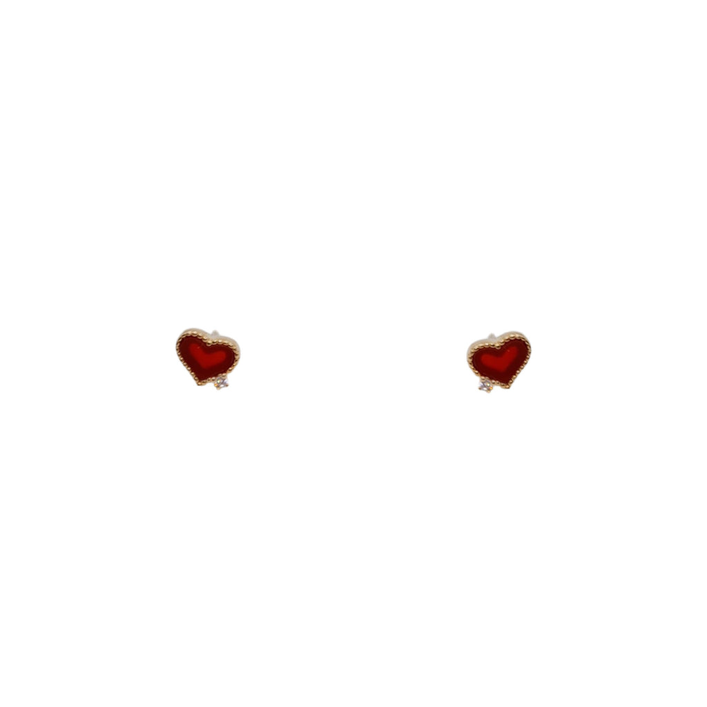 Red heart stud earrings on white background