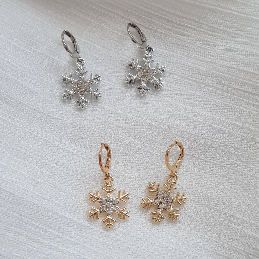 Gold and silver snowflake huggie earrings