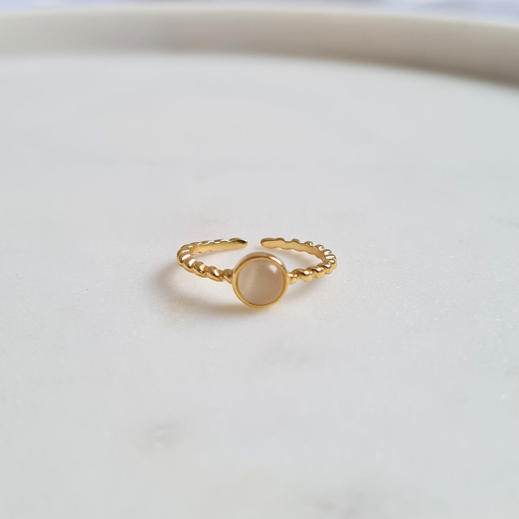 Opal ring on white background