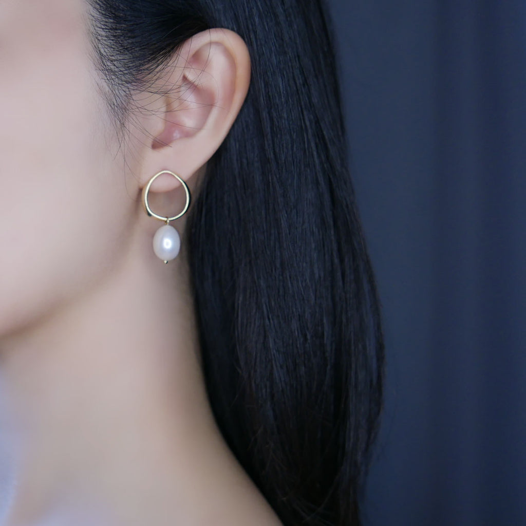 Model wearing gold Ella Pearl Drop Earrings