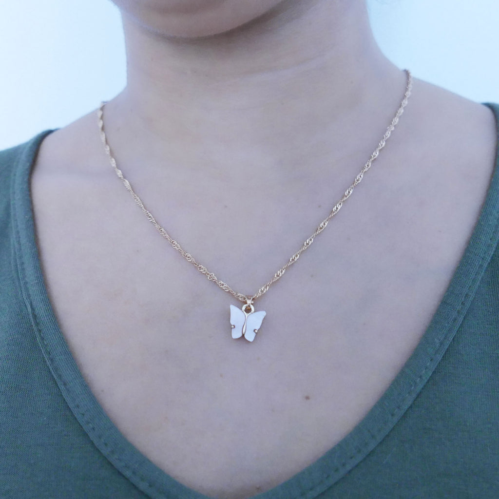 Light pink butterfly necklace on model