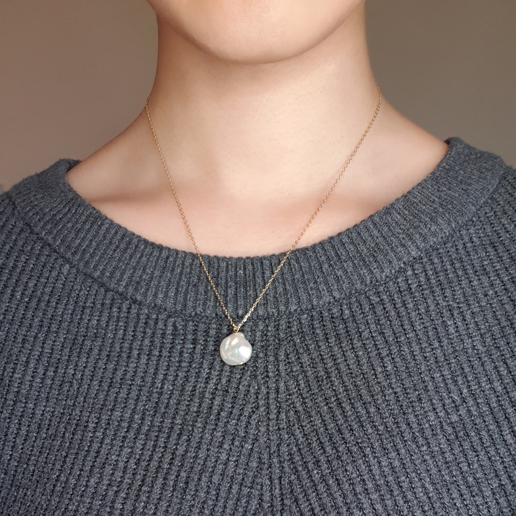 Gold chain, small baroque pearl freshwater necklace on model wearing grey jumper