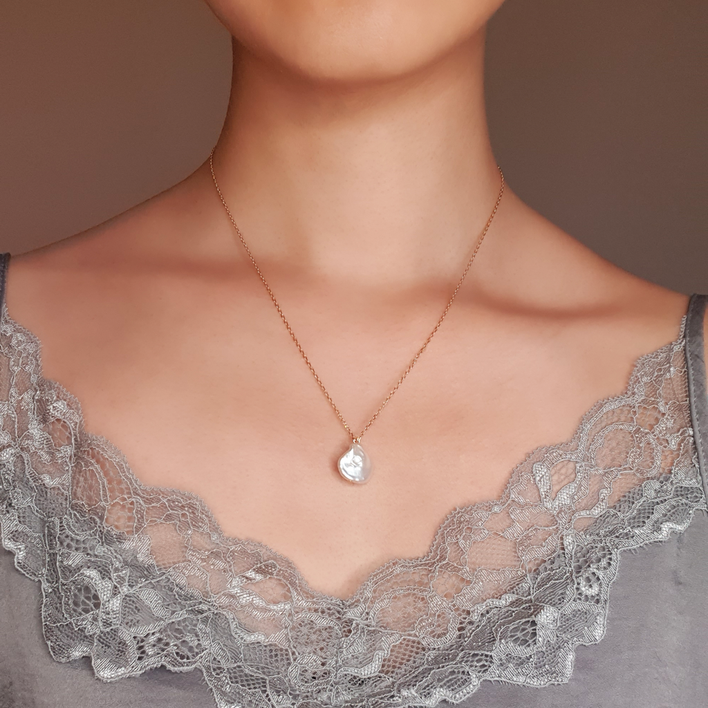 Gold chain, small baroque pearl freshwater necklace on model wearing silver lace top