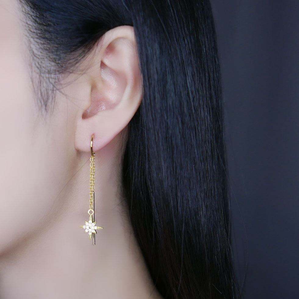 Model wearing gold shining star threader earring